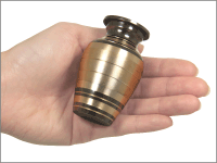egyptian small keepsake urn shown in hand for size comparison