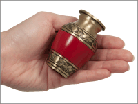 cherry red small keepsake urn shown in hand for size comparison