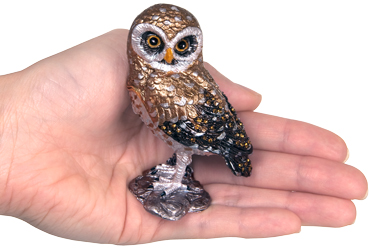 owl cremation urn keepsake shown with hand for size scale