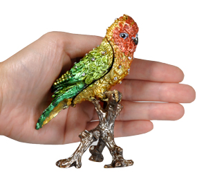 summer lovebird cremation urn keepsake shown with hand for size scale
