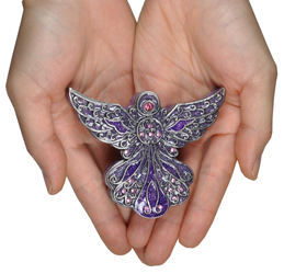 purple angel cremation keepsake shown in hands for size scale