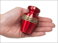 scarlet small keepsake urn shown in hand for size comparison