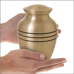 Brass Sharing 6 inch cremation urn shown in hands for size