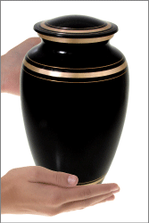 plain black gold cremation full size urn shown in hands for size scale
