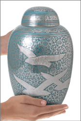 Fly Away Home Cremation Urn shown in hands for size scale