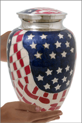 American Flag Brass Cremation Urn shown in hand for size scale