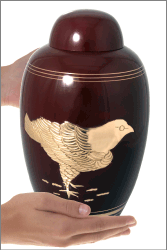 Golden Feathered Protector Cremation Urn shown in hands for size scale