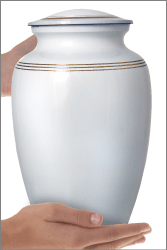 White Classic Cremation Urn shown in hands for size scale