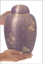Butterfly- Purple Cremation Urn shown in hands for size scale