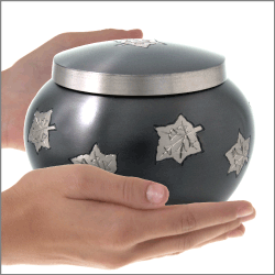 falling leaves sharing urn shown in hands for size reference