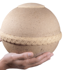 biodegradable geos urn shown in hands for size scale