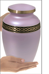wholesale cremation urns pink celtic gold band shown in hands for size scale