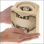 pet keepsake urn shown in hands for size scale