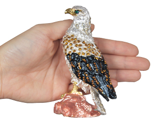 eagle cremation urn keepsake shown with hand for size scale