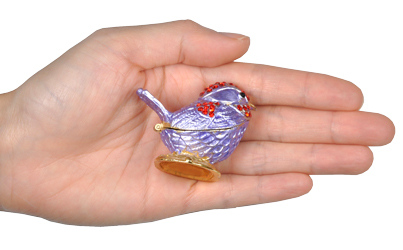 lavender bird shown in hand