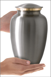Traditional Two-tone Brass Cremation Urn shown in hand for size scale