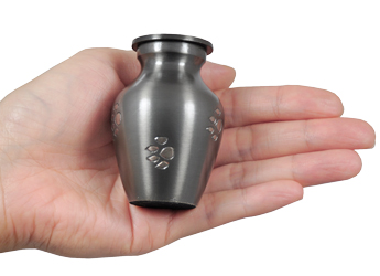 wholesale pet cremation urn pawprints slate grey mini keepsake shown in hands for size scale