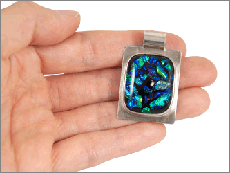 dichroic glass sterling rectangle shown in hand for size scale
