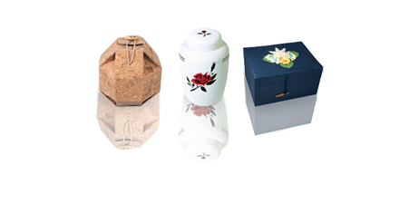 variety of biodegradable urns shown; for ground burial